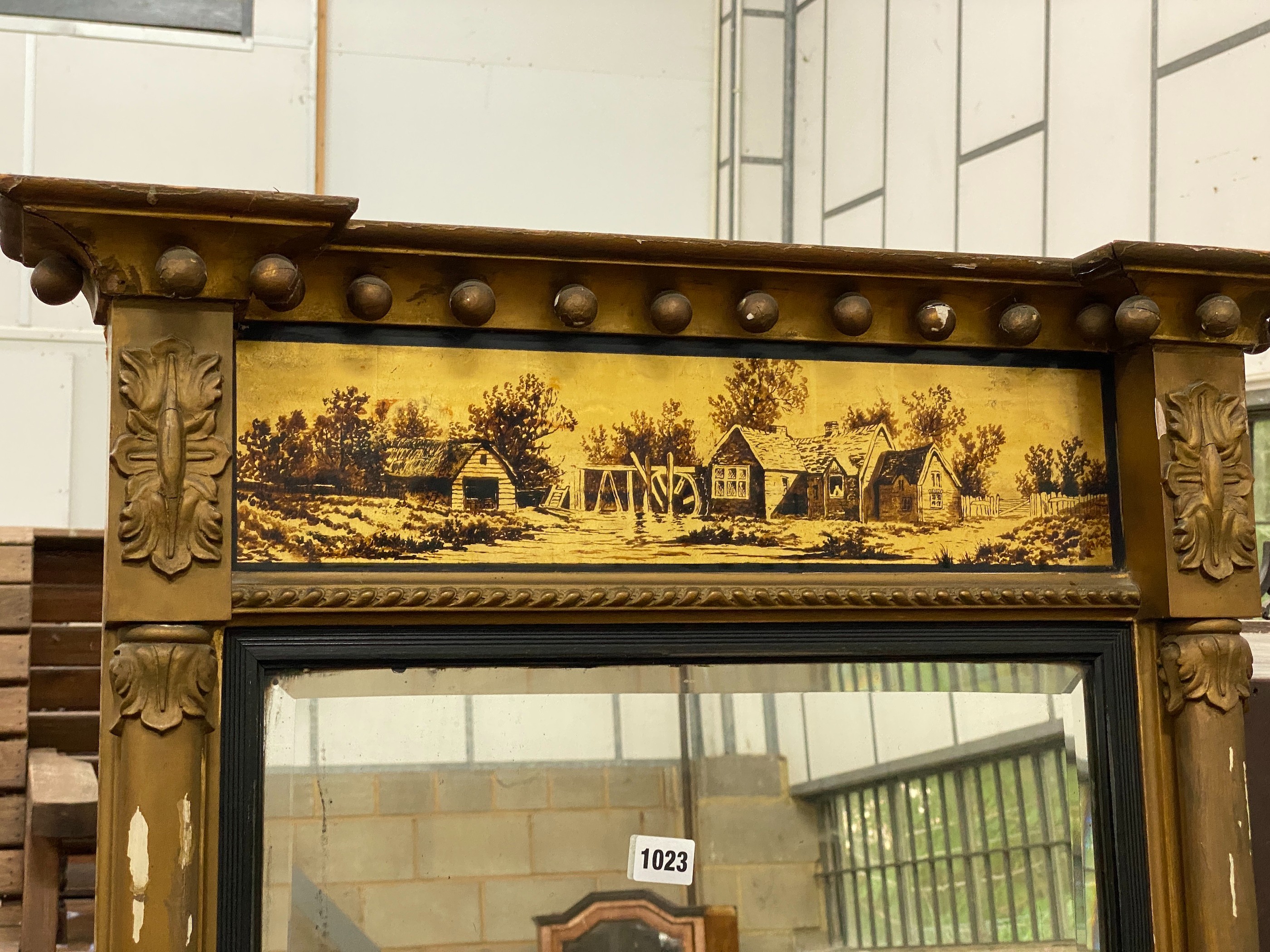 A Regency giltwood pier glass, with a verre eglomise frieze, width 69cm, height 103cm